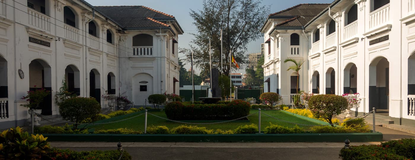 Nalanda Junior Old Boys Association backdrop image showing the school campus at dusk